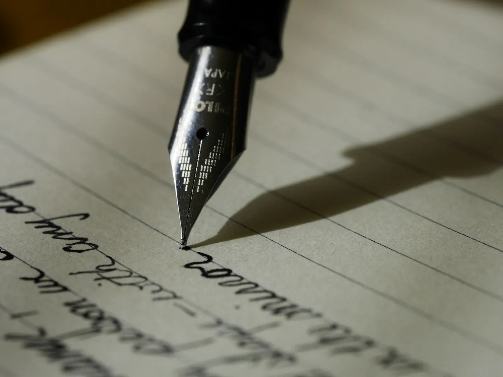 Fountain pen nib on handwritten page